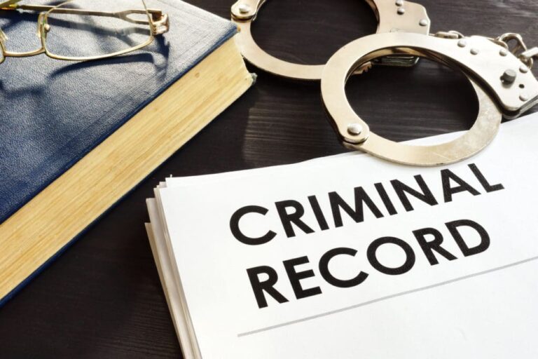 Criminal record file with handcuffs and gavel symbolizing law enforcement and justice.