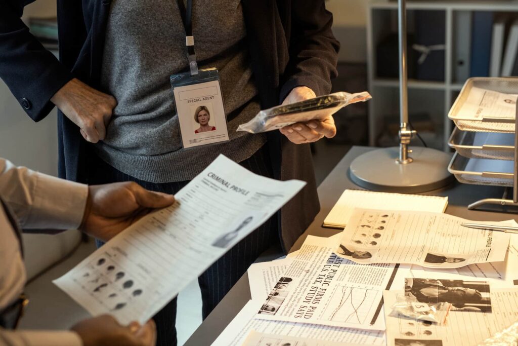 Investigators reviewing documents and evidence similar to employment background check work
