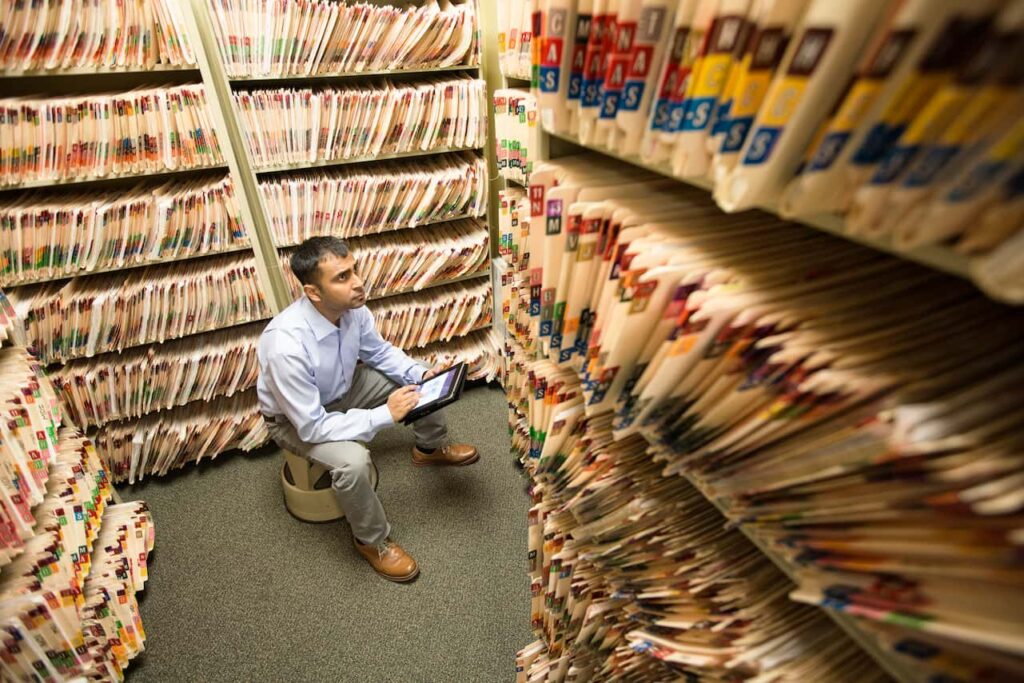 Staff member reviewing archived files related to record sealing and set aside options