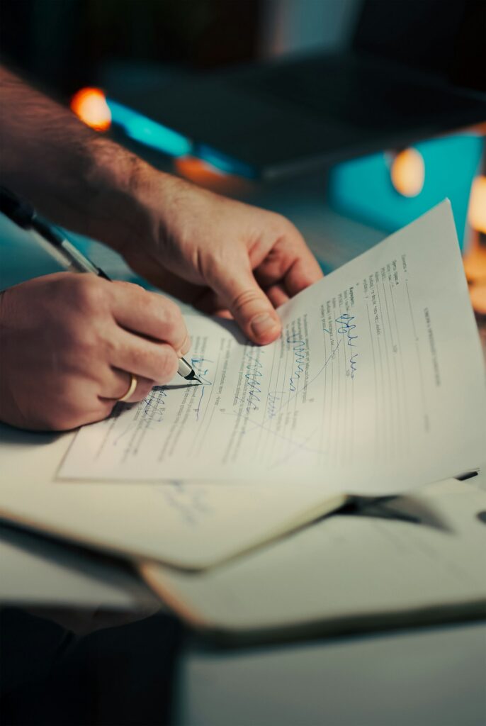 Hands Signing Pen