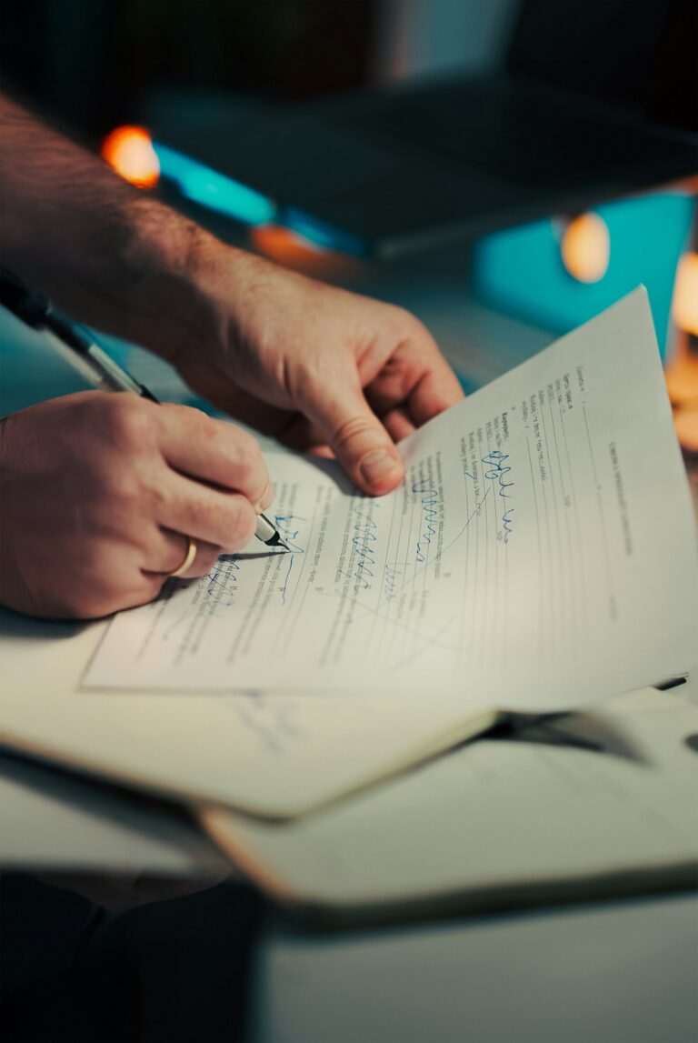 Hands Signing Pen