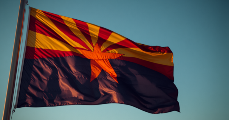 Arizona flag's star and rays fill the frame against blue sky